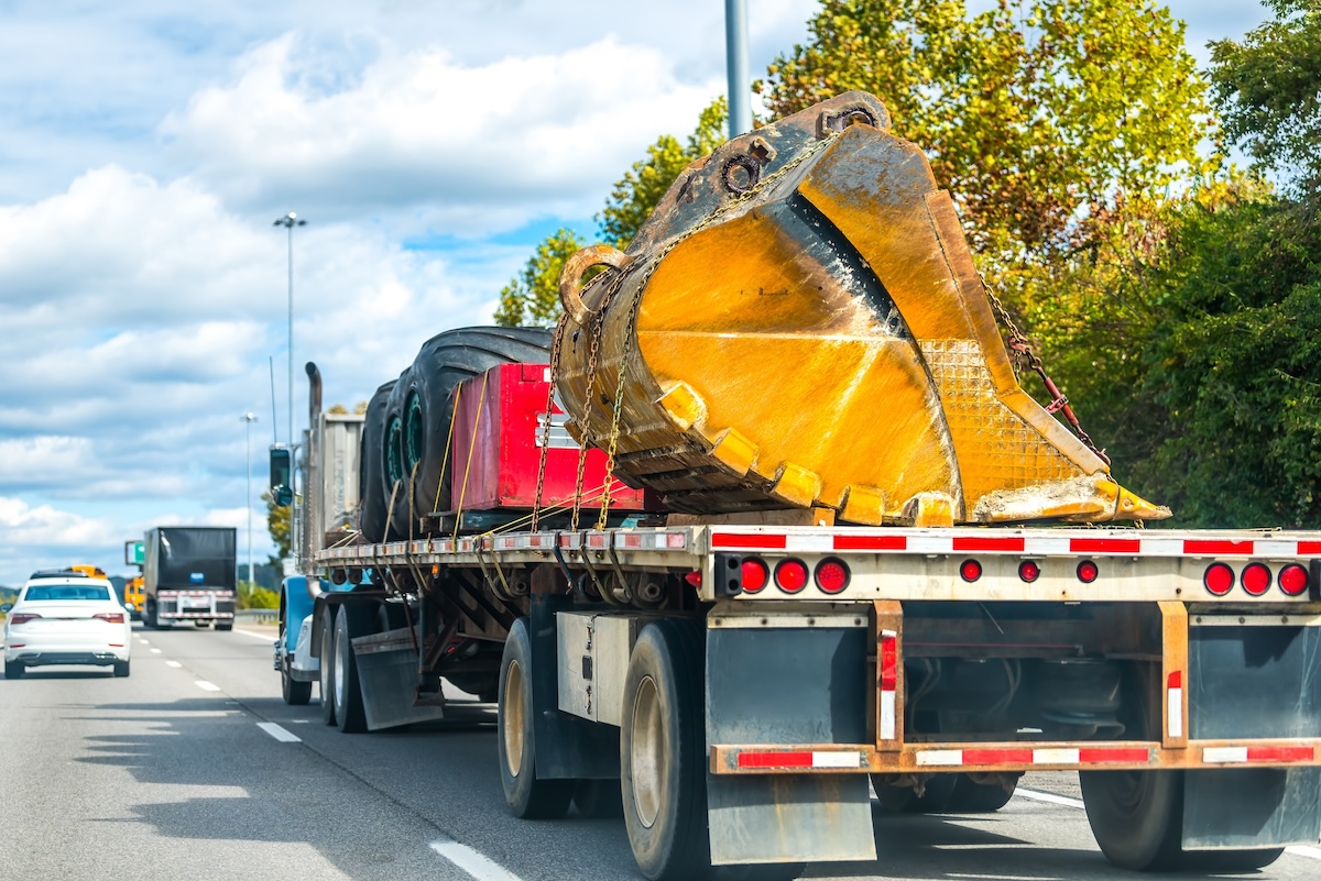 Flatbed truck carrying construction equipment