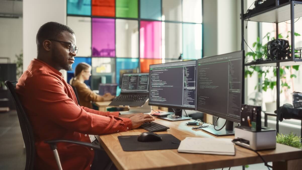 Office environment with two people working at computers