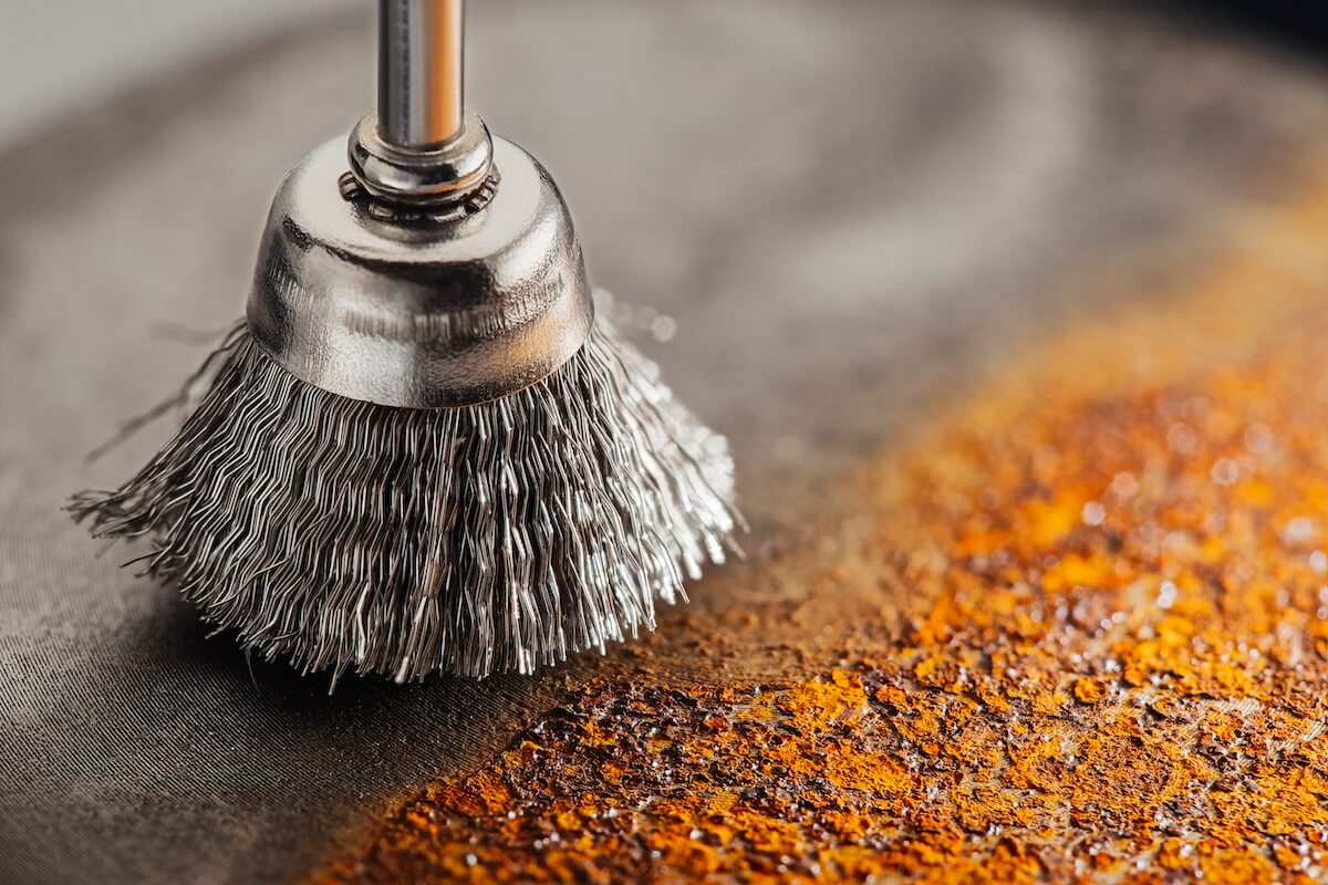 Stripping away metal with a metal brush