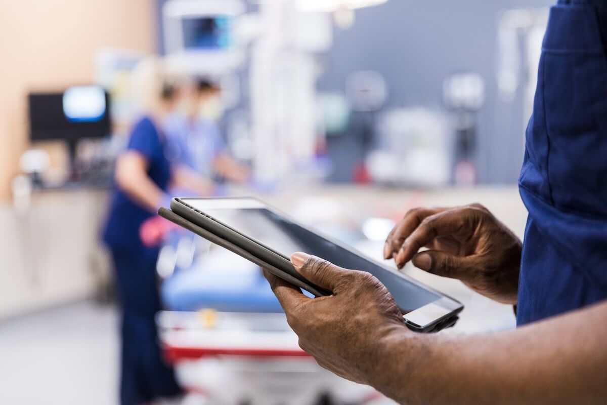 Healthcare professional using tablet in hospital setting