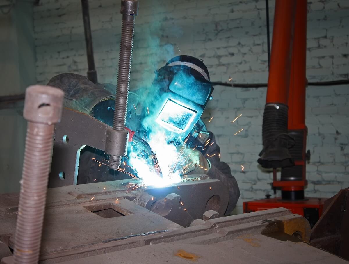 Person fabricating steel by welding