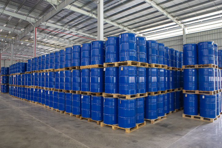Bulk chemicals in blue drums purchased by a small business.